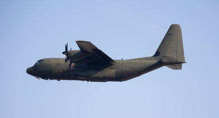 Military transport aircraft equipped with four powerful turbocharged engines is flying in sky