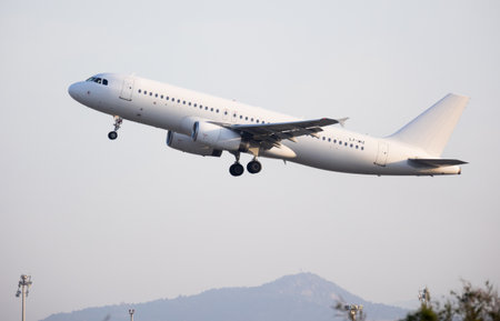 Aircraft of Lithuanian charter airline Getjet is taking off against urban background, palm branchのeditorial素材