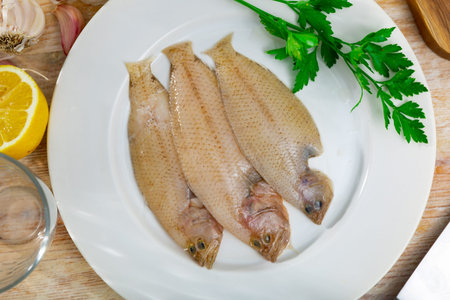 Spotted flounder served with parsley on plate