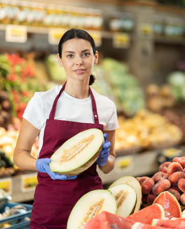 Woman presents melon, best option of vegetables from local and imported producersの写真素材