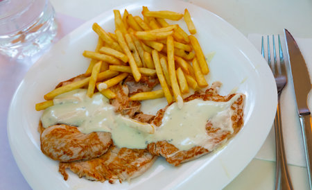 Pork tenderloins with fried potatoesの写真素材