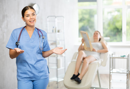 Young woman doctor posing in medical roomの写真素材