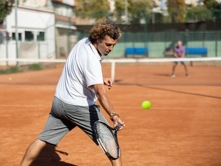 man playing tennis in the city courtの写真素材