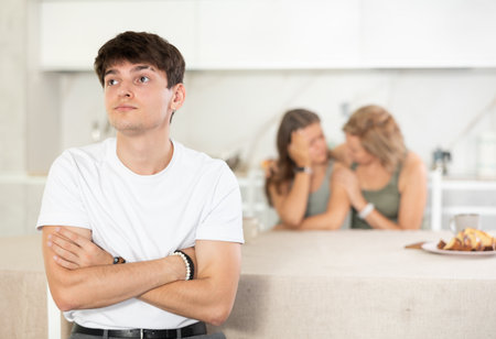 Quarrel of mom, girl and young guy. Woman and girl shouts at guy and accuses herの写真素材