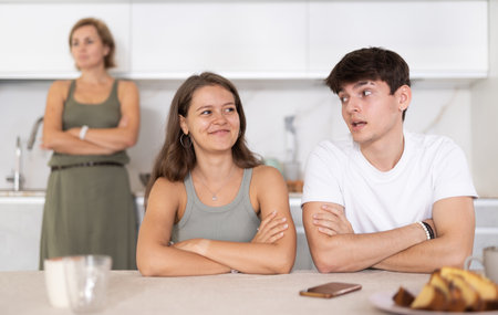 Portrait of thoughtful woman who had conflict with adult children while cooking dinner in kitchenの写真素材
