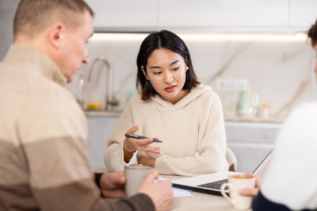 Female realtor tells two men the terms of rental agreementの写真素材