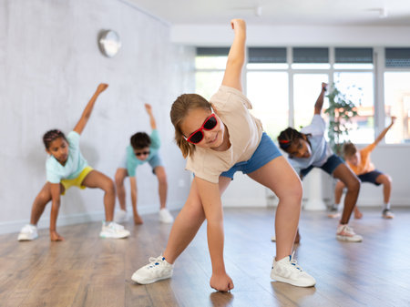 Girl perform choreographic exercise and teach social dance Jazz-modern with friendsの写真素材