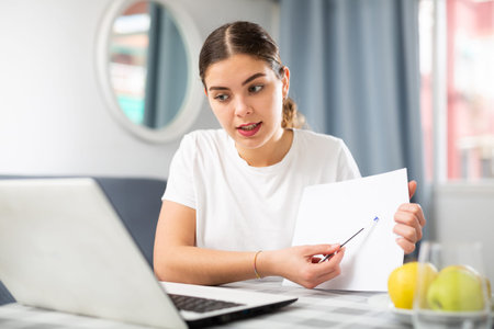 Woman studying during online courses using laptop