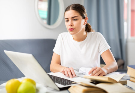 Woman studying during online courses using laptop