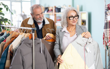 Elderly couple choosing jackets and coats togetherの写真素材