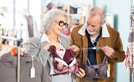 Mature couple spend time in shop and choose bra lingerie setの写真素材