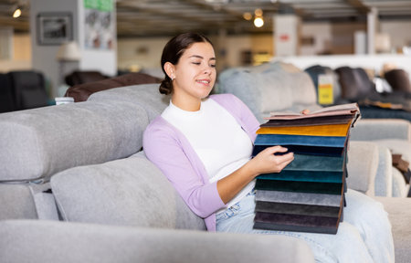 girl on the sofa infurniture store decides what fabric to chooseの写真素材