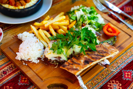 Tasty lamb ribs baked and served with rice, potatoes and vegetables