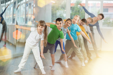 Preteen children engaged in choreography exercises in group
