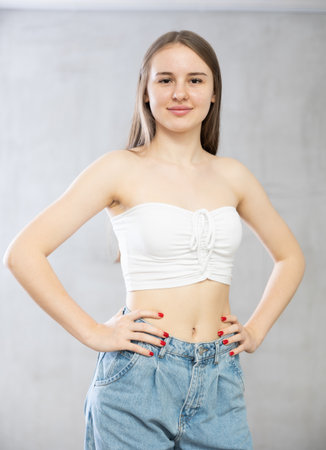 Portrait of young girl on grey background studio portraitの写真素材