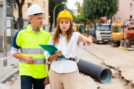 Civil engineers checking work process in construction siteの写真素材
