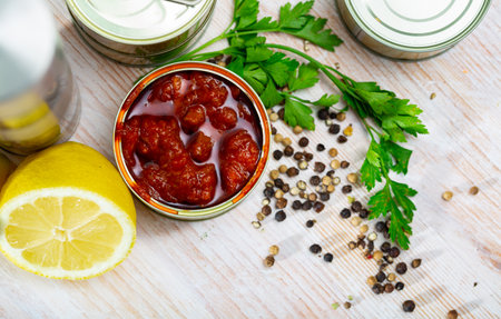 Tasty squids in American Salsa on background with greens and lemonの写真素材