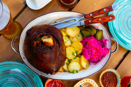 Roasted pork knuckle with potato and pickles