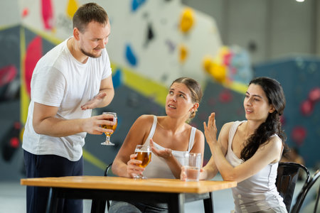 Man tries to pick up young girls after rock climbing training. Girls refuse to talk to him.