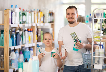 Man and boy choosing dental care productsの写真素材