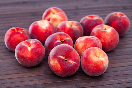 Juicy ripe peaches on wooden tableの写真素材