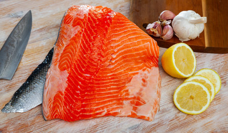 Raw red fish salmon fillet, lemon, parsley