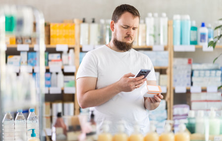 Man scans code on package of pills to check expiration dateの写真素材
