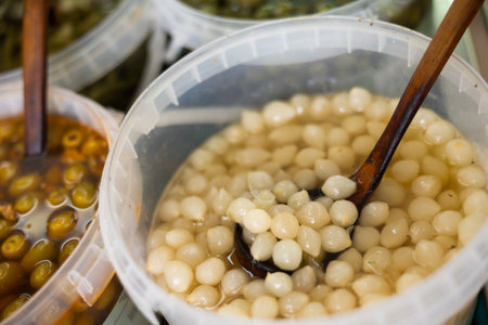 Marinated onion in plastic containers on a shelfの写真素材