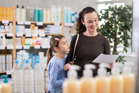 Woman with daughter choosing drugsの写真素材