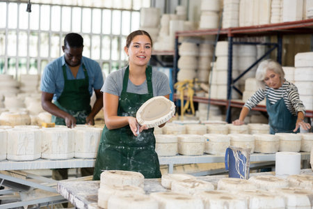 Positive woman potter with form for new ware