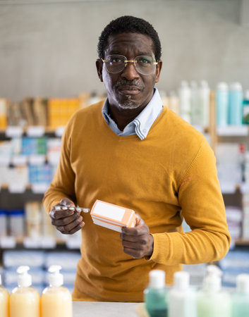 African man choose buy painkiller tablet at pharmacyの写真素材