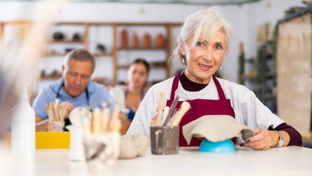 elderly woman is working with billetの写真素材