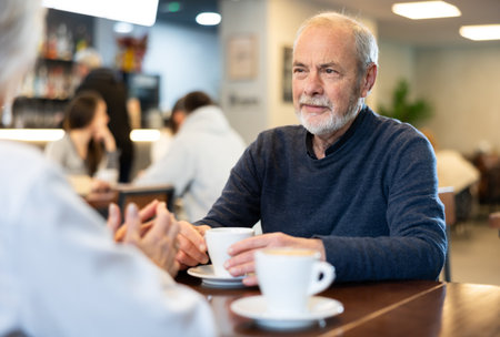 Couple of men and women talking and drinking coffeeの写真素材