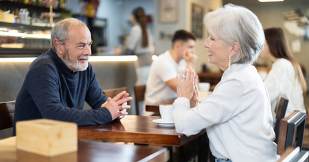 Couple of men and women talking and drinking coffeeの写真素材