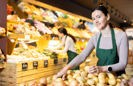 Female employee informs about arrival of ripe potato, advertises product