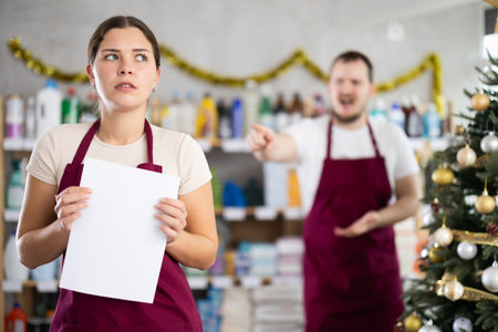 Male manager is unhappy with female salesperson - he yells at herの写真素材