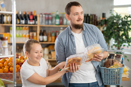 Man with son holding plastic containers.