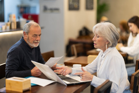 Elderly couple at a business meeting in a cafe