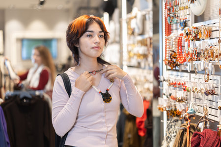 Young Asian woman chooses stylish jewelry