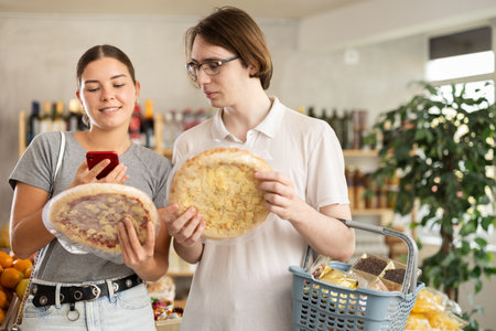 In shop European youth scan QR code and take reading pizza using phone cameraの写真素材