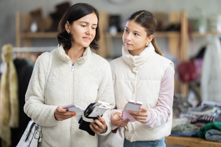 Adult woman and teenage girl choose socksの写真素材