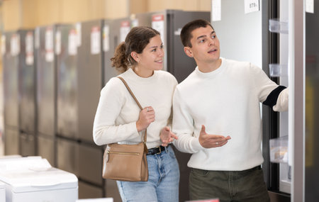 Couple choosing a refrigerator in an equipment storeの写真素材