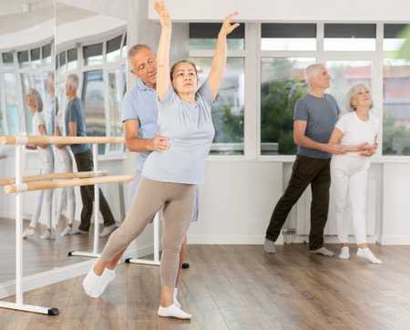 Elderly couples learning to dance ballet in dance studio