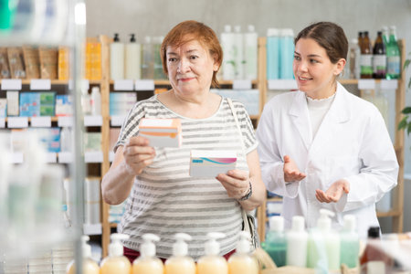 Female pharmacist making recommendations to buyerの写真素材