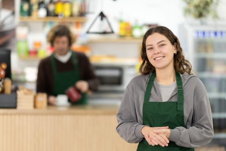 Female cafe employee carries coffee in cozy cafe