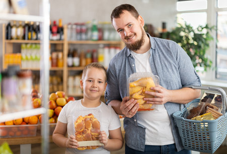 Man with son holding plastic containers, choose chicken meat.の写真素材