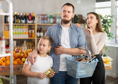 Friendly family shopping for groceries in supermarketの写真素材
