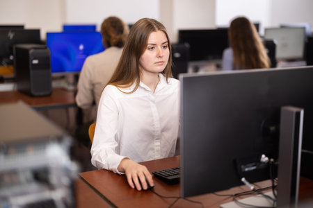 Female student at computers in university computer class