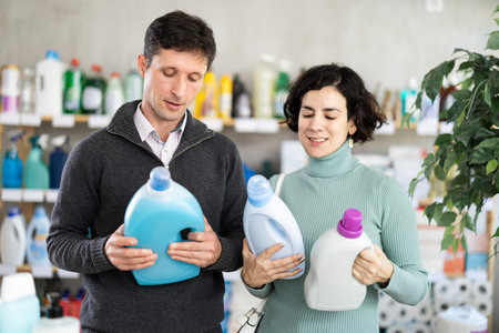Married couple choosing detergent in the storeの写真素材