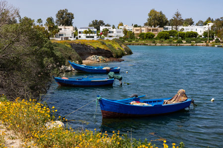 Blue waters and moored boatsの写真素材